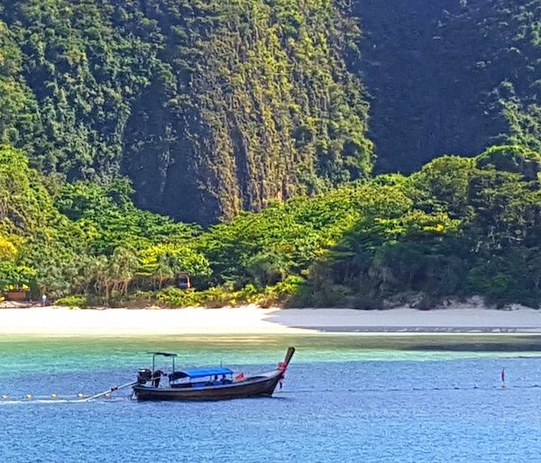 Traditional Longtail boat with an idyllic backdrop