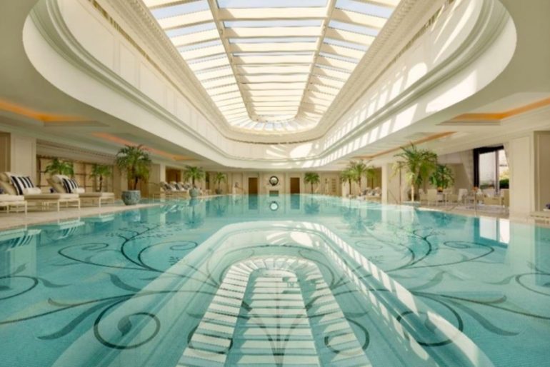 The Peninsula Shanghai’s indoor pool is awash in natural light that showcases an elegant tile mosaic pattern