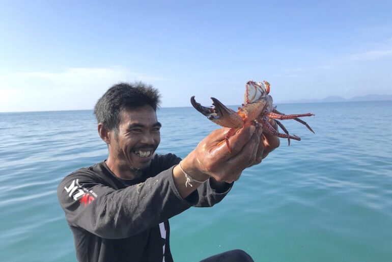 Cha's husband proudly shows us the best crab of the day