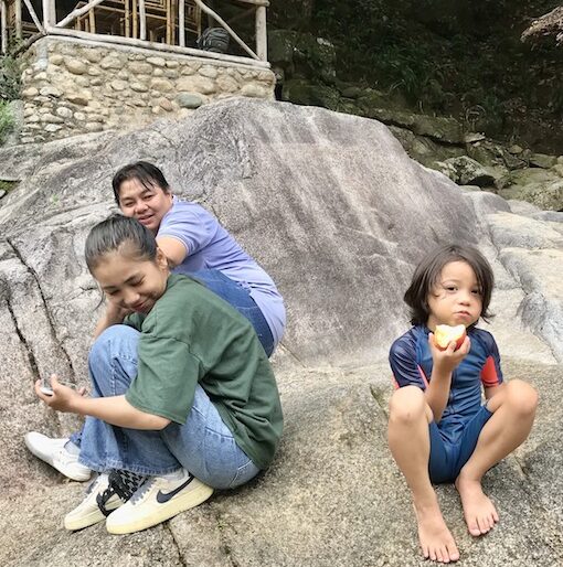 Leonardo on a boulder with Hoang and Lee